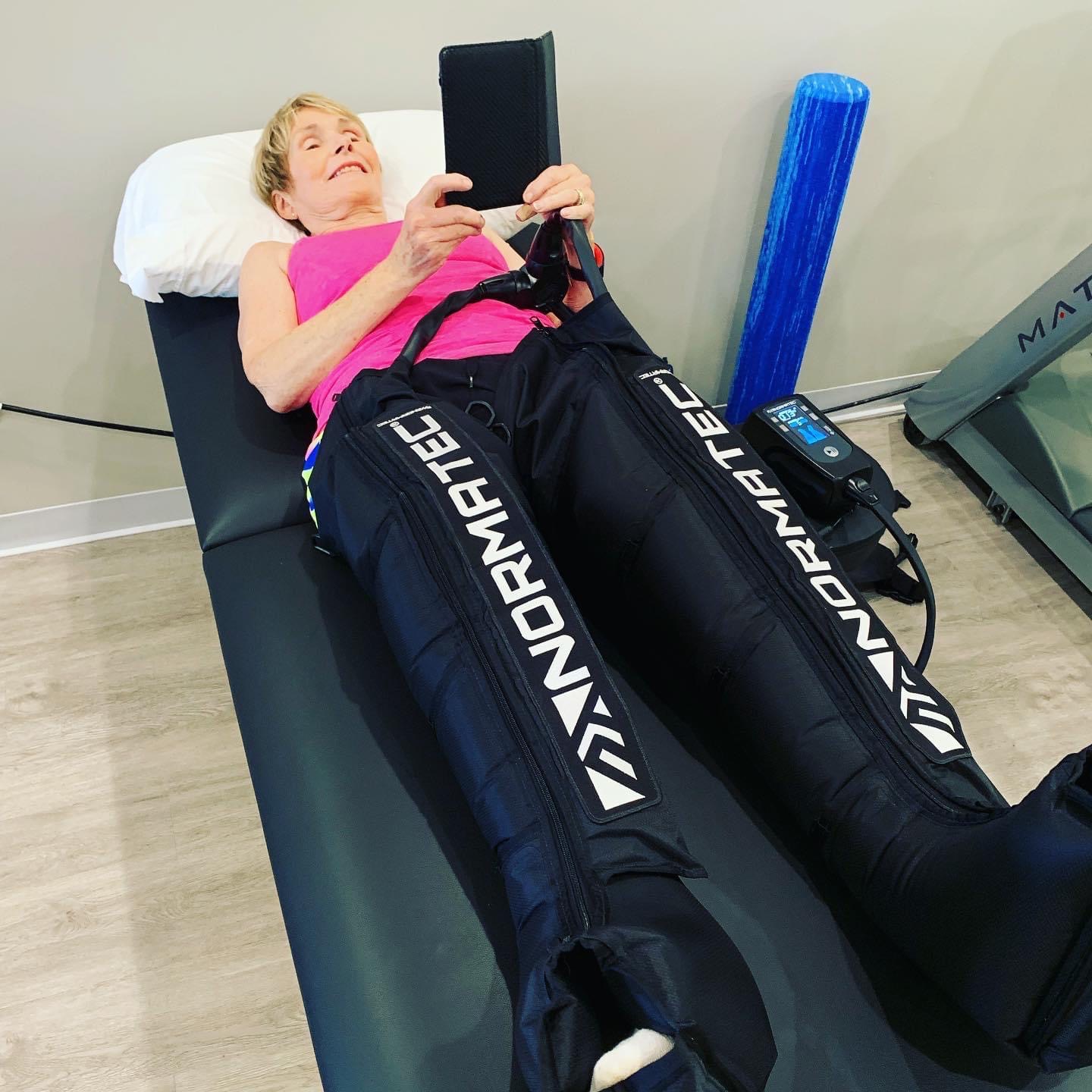 A patient finds relief using the Normatech technique to treat her condition at PRIME Physical Therapy.