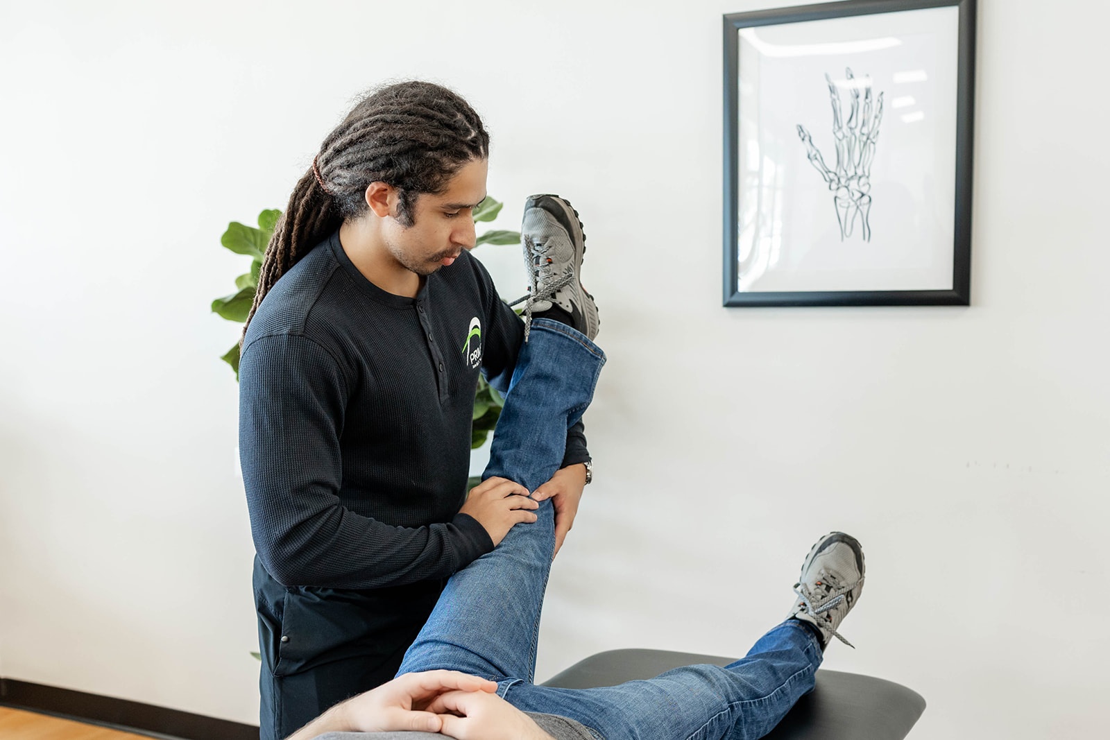 Dr. Laura Yoo pushes weights during a fitness class as fellow fitness members cheer for her.