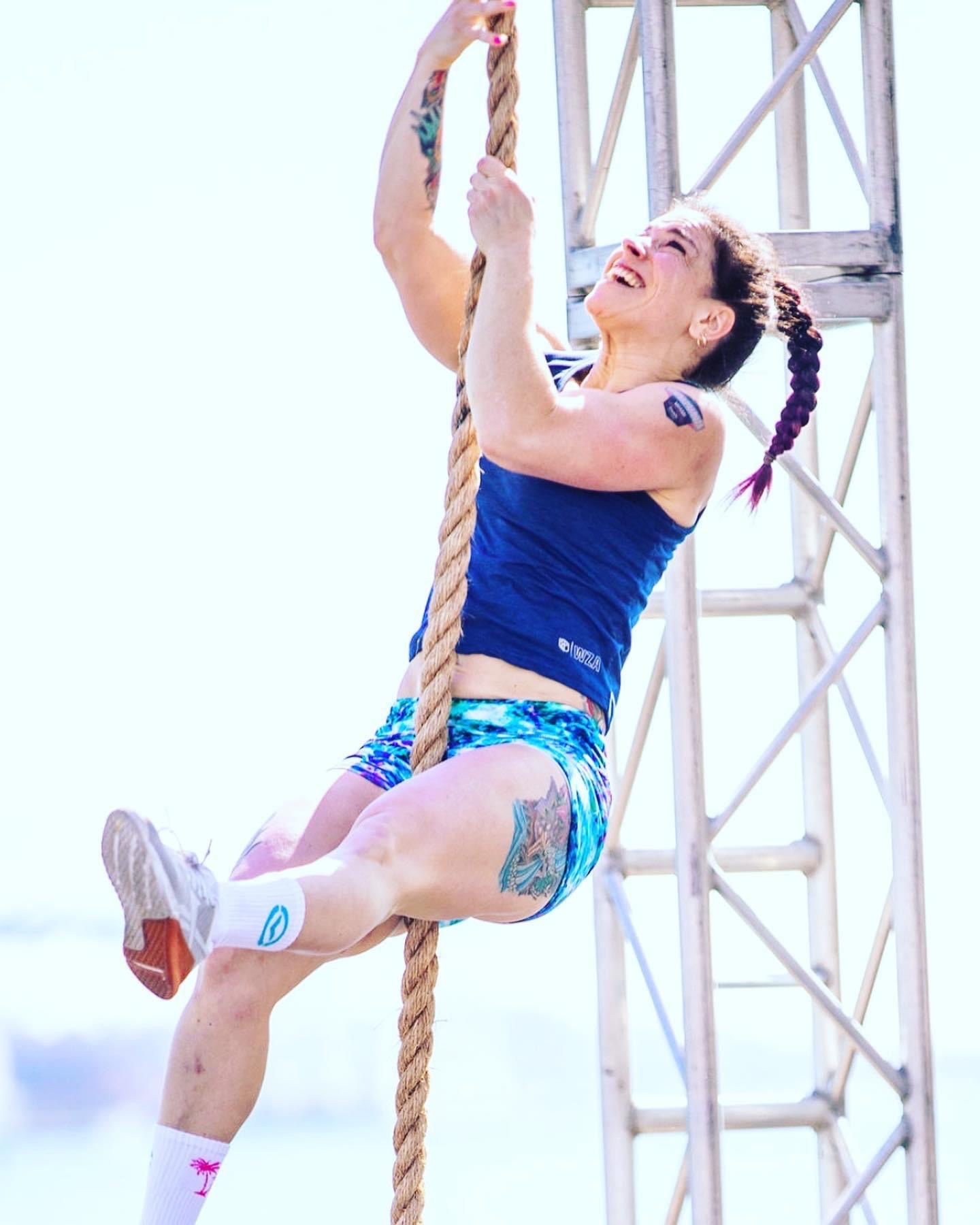 PRIME PT Course instructor Dr. Tami scales a rope at a CrossFit competition.