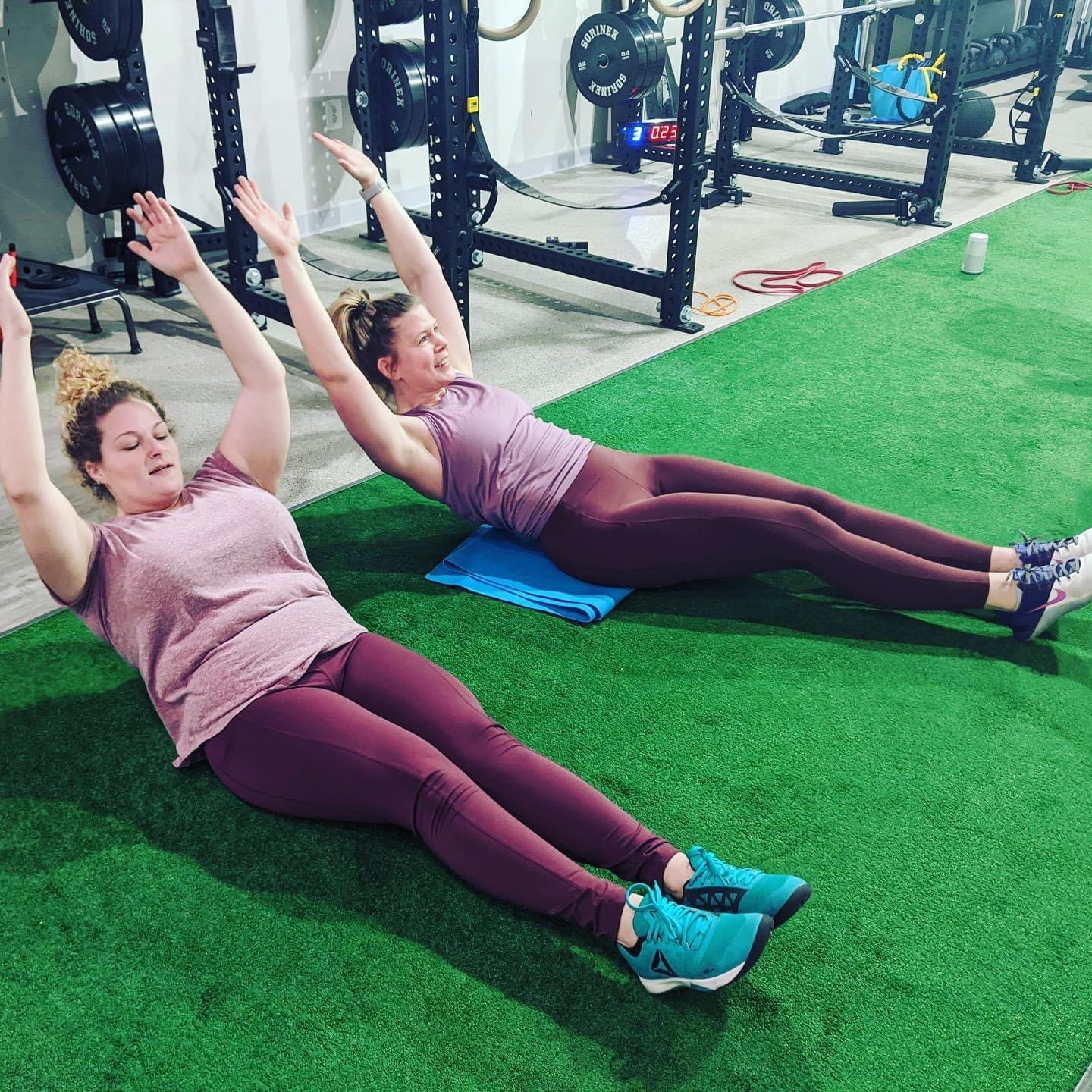 Amanda C. and Dr. Laura Yoo exercise together during PRIME Physical Therapy's fitness class.