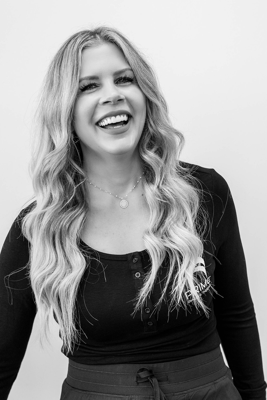 Dr. Laura Yoo, owner and operator of PRIME Physical Therapy, visits with a patient about proper form while lifting weights.