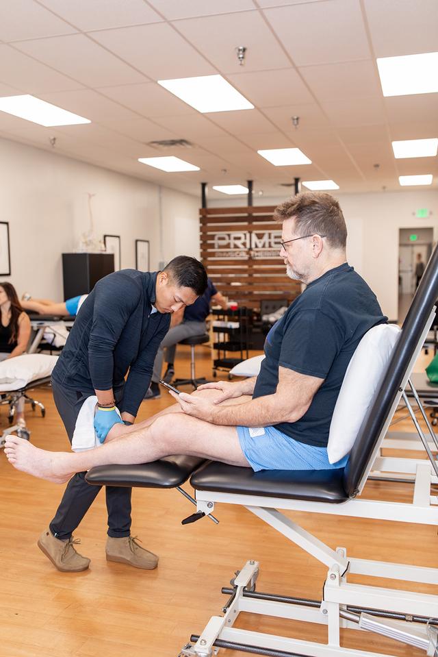 Dr. Tami treats a patient's leg at PRIME Physical Therapy in Eldersburg, Maryland.